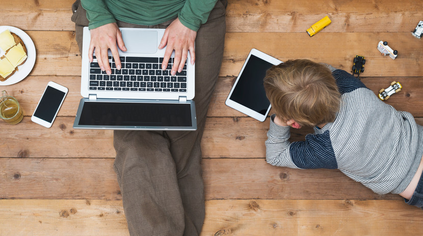 top view of mother and son using digital media. Modern online generation addicted to internet.